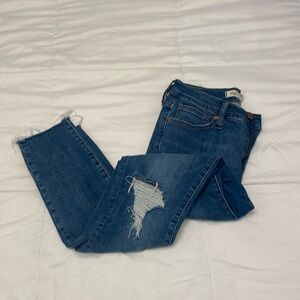 Distressed Madewell skinny mid rise medium wash